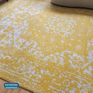 yellow designer area rug with sofa on top
